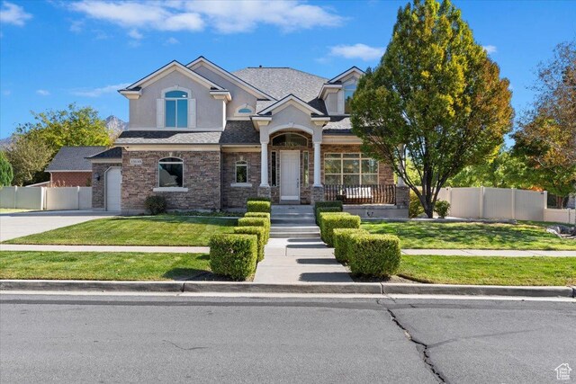 13133 S Crystal Springs Dr, Draper, UT 84020 - view of front of property featuring driveway, stone siding, and a garage