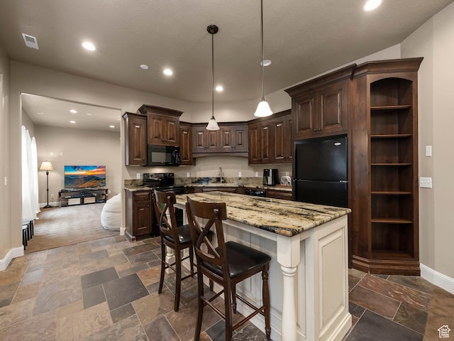 1212 N Heritage Cir, Alpine, UT 84004 - kitchen featuring black appliances, dark brown cabinetry, stone tile floors, recessed lighting, and light stone counters