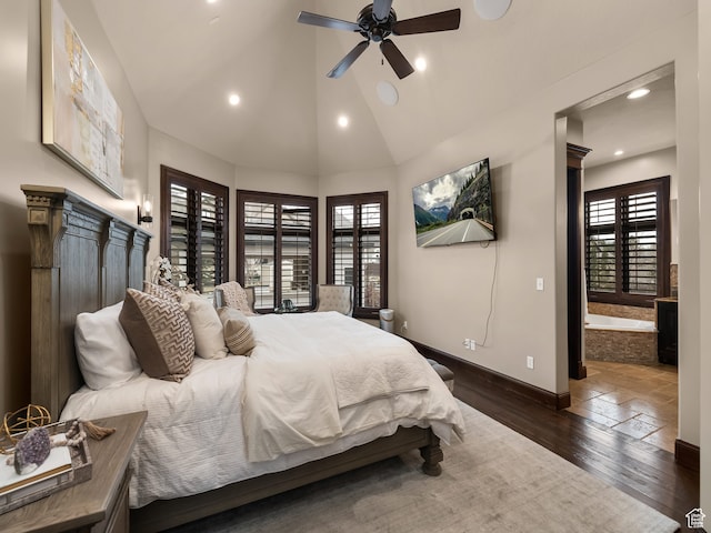 bedroom featuring ceiling fan, ensuite bath, vaulted ceiling, and dark wood-type flooring