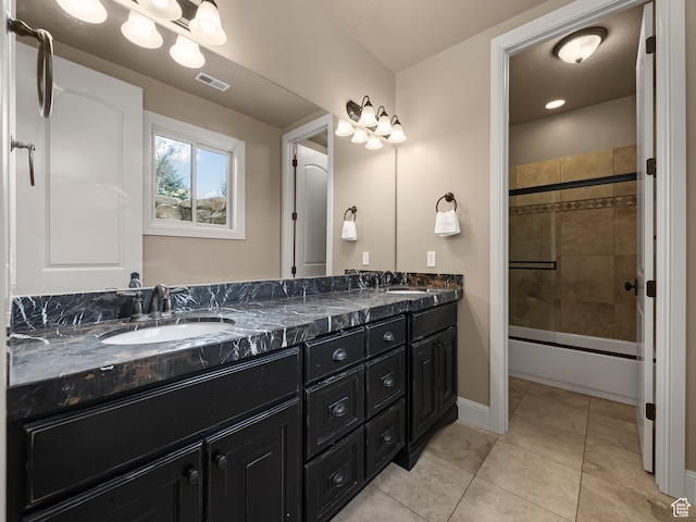 bathroom with tile patterned floors, enclosed tub / shower combo, and vanity
