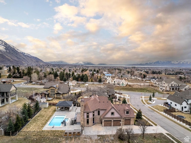 aerial view at dusk featuring a mountain view