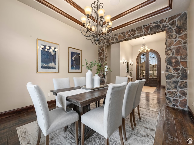 dining area featuring french doors, dark hardwood / wood-style floors, and an inviting chandelier