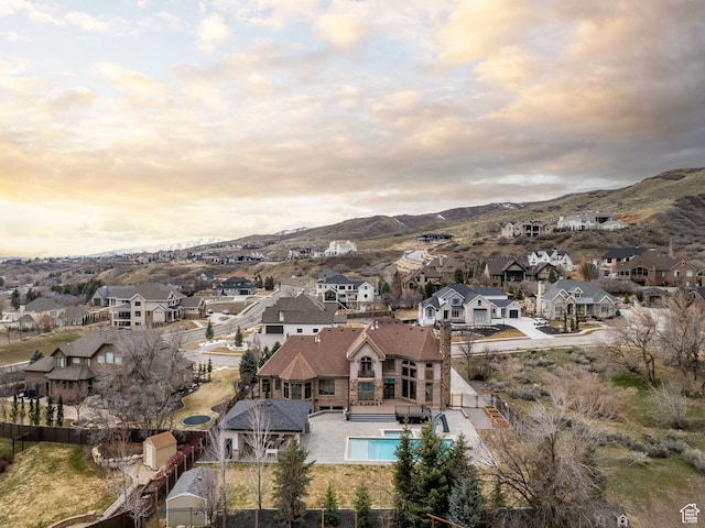 aerial view at dusk featuring a mountain view