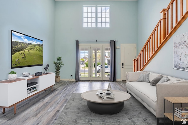 4489 W Milford Dr, South Jordan, UT 84009 - living area with french doors, wood finished floors, baseboards, a high ceiling, and stairs
