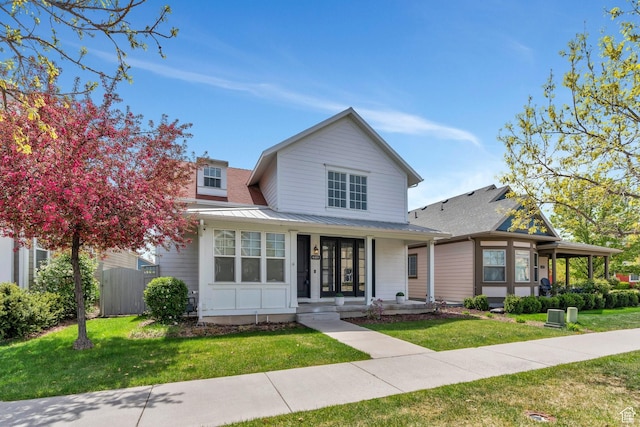 4489 W Milford Dr, South Jordan, UT 84009 - view of front of home featuring fence, covered porch, a front yard, and metal roof