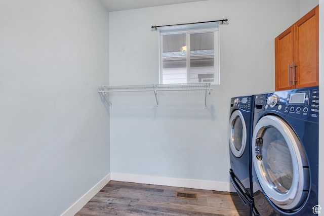 4489 W Milford Dr, South Jordan, UT 84009 - washroom with visible vents, washing machine and dryer, wood finished floors, baseboards, and cabinet space