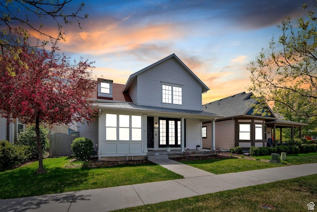 4489 W Milford Dr, South Jordan, UT 84009 - view of front of house with a lawn, metal roof, a standing seam roof, and a porch