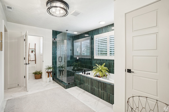 bathroom featuring a shower stall, marble finish floor, visible vents, and a bath