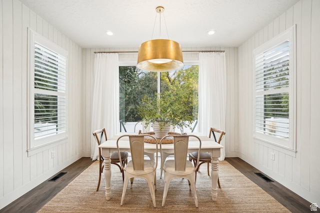 dining area featuring a wealth of natural light, dark wood-type flooring, and visible vents