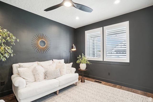 living room featuring wood finished floors, visible vents, recessed lighting, ceiling fan, and baseboards