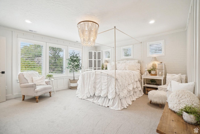 bedroom with carpet, visible vents, recessed lighting, crown molding, and a notable chandelier