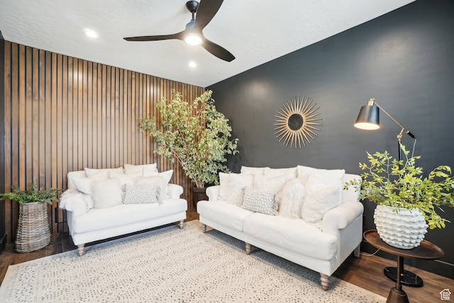 living area featuring recessed lighting, wooden walls, ceiling fan, and wood finished floors