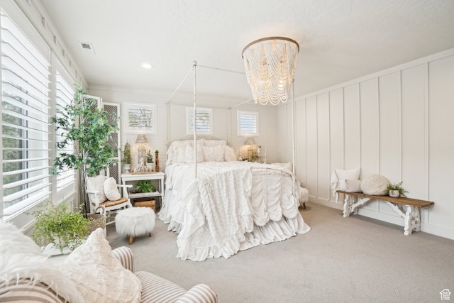 bedroom with an inviting chandelier, visible vents, and carpet