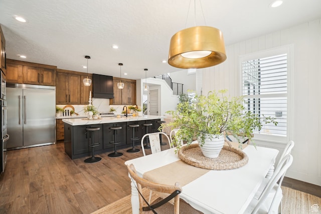 dining room with recessed lighting and dark wood-type flooring