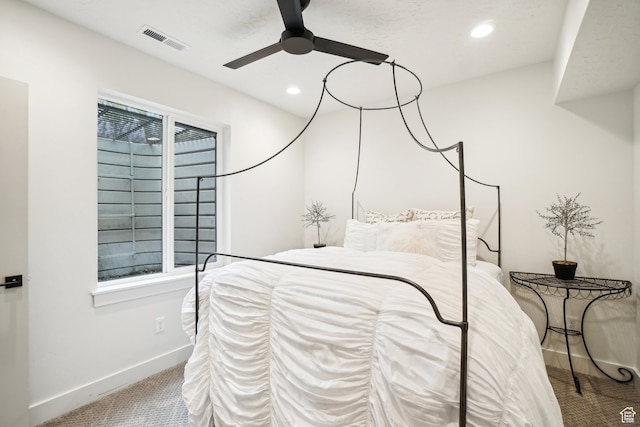 carpeted bedroom featuring baseboards, recessed lighting, visible vents, and a ceiling fan