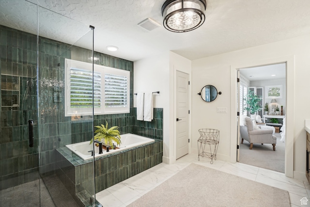 bathroom with a stall shower, marble finish floor, visible vents, and a bath