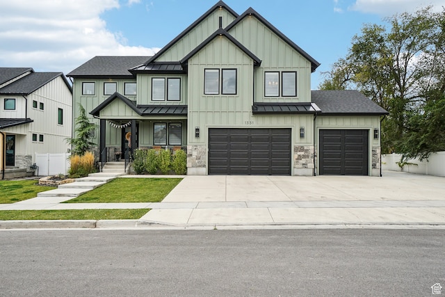 modern inspired farmhouse featuring board and batten siding, driveway, fence, and a standing seam roof