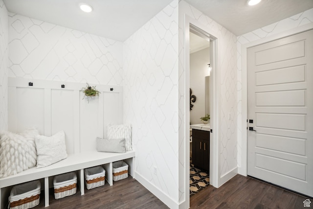 mudroom with baseboards, dark wood-style floors, wallpapered walls, and recessed lighting