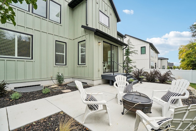 view of patio featuring a fire pit and fence