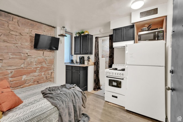 276 E Broadway St S Unit 3, Salt Lake City, UT 84111 - kitchen with white appliances, under cabinet range hood, light wood-style flooring, dark cabinetry, and light countertops