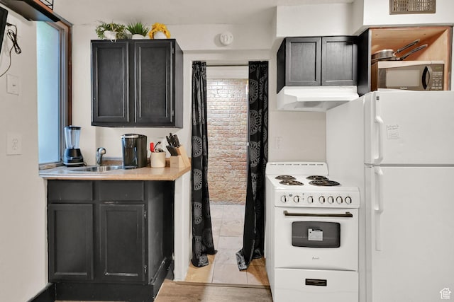 276 E Broadway St S Unit 3, Salt Lake City, UT 84111 - kitchen featuring white appliances, exhaust hood, light countertops, dark cabinets, and a sink