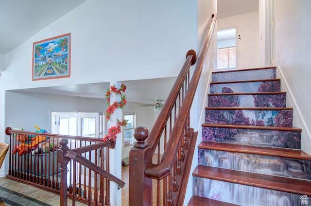 stairs with high vaulted ceiling