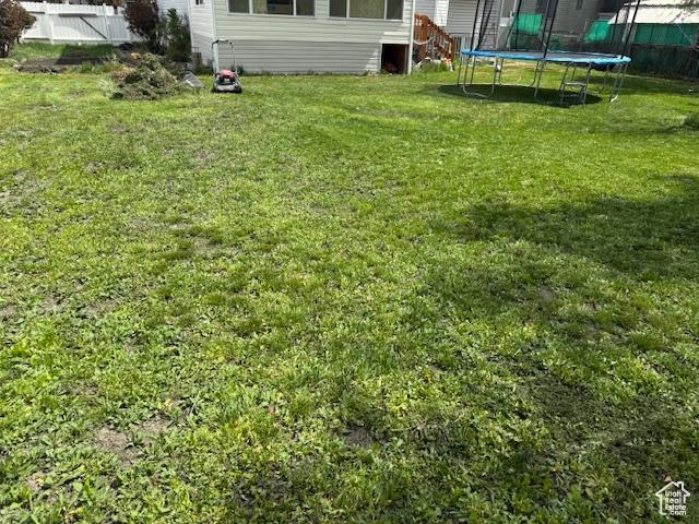view of yard with a trampoline