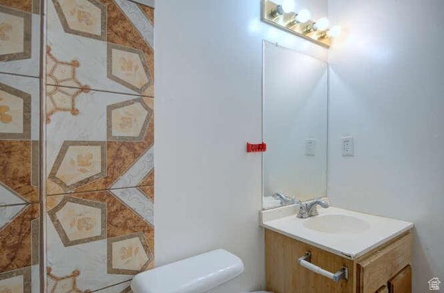 half bathroom featuring toilet and vanity