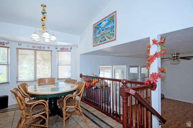 dining space featuring a chandelier, a ceiling fan, high vaulted ceiling, and light tile patterned floors