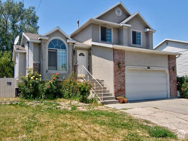 view of front of home featuring stucco siding, concrete driveway, brick siding, and an attached garage