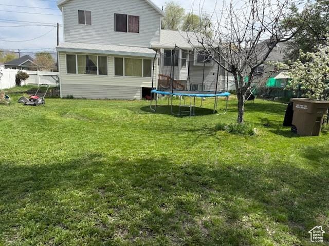 back of house featuring a trampoline