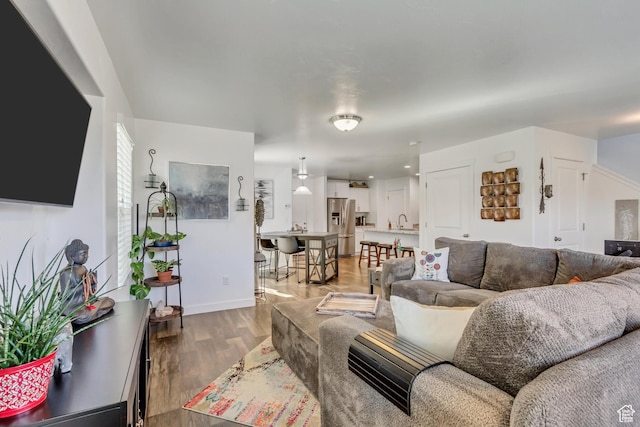 living room featuring baseboards and light wood-style flooring