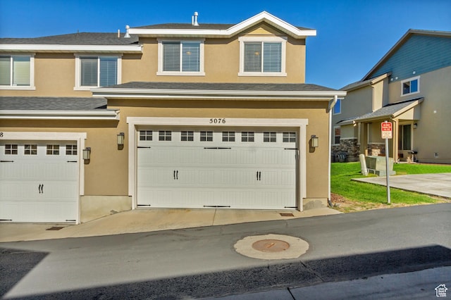 view of front of house featuring stucco siding and an attached garage