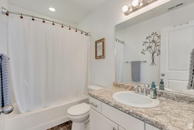 bathroom featuring visible vents, vanity, wood finished floors, toilet, and shower / bath combo