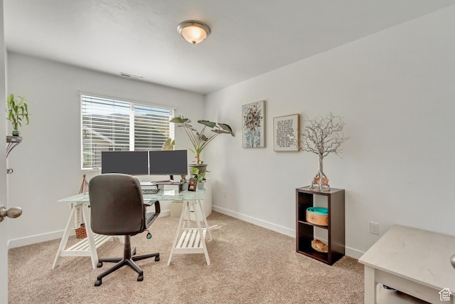 office area featuring carpet flooring, baseboards, and visible vents
