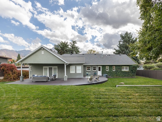 1975 E Gunderson Ln S, Holladay, UT 84124 - rear view of house with a patio, a mountain view, and a lawn