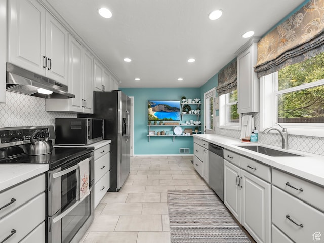 1975 E Gunderson Ln S, Holladay, UT 84124 - kitchen with sink, decorative backsplash, appliances with stainless steel finishes, and white cabinetry