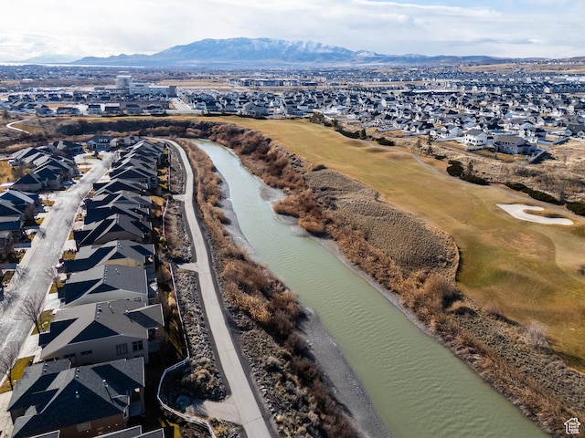 drone / aerial view featuring a residential view and a water and mountain view