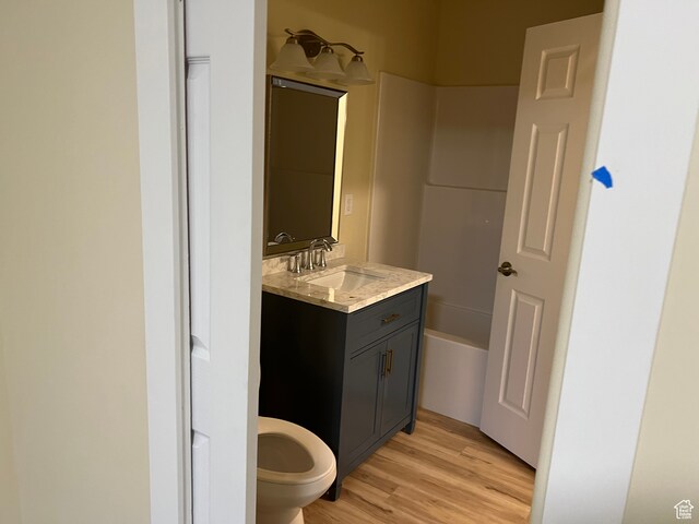 415 N 1st St W, Downey, ID 83234 - bathroom with vanity, hardwood / wood-style floors, a bathtub, and toilet
