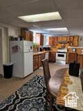 50 W 100 N, Salina, UT 84654 - kitchen featuring freestanding refrigerator and brown cabinets