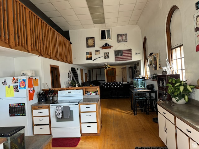 50 W 100 N, Salina, UT 84654 - kitchen with white appliances, dark countertops, arched walkways, light wood finished floors, and a drop ceiling