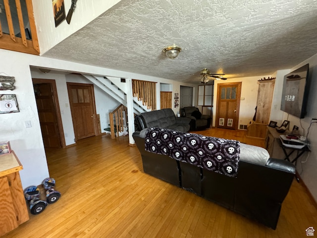 50 W 100 N, Salina, UT 84654 - living room featuring hardwood / wood-style flooring, stairway, a ceiling fan, and a textured ceiling