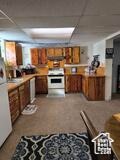 50 W 100 N, Salina, UT 84654 - kitchen with stove, a paneled ceiling, and brown cabinets