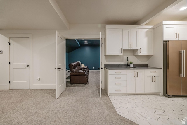 104 S 950 E, Hyde Park, UT 84318 - kitchen featuring freestanding refrigerator, white cabinetry, dark countertops, a sink, and light carpet