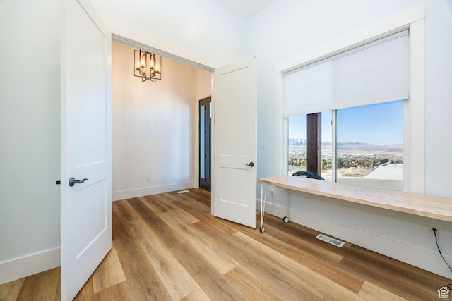 104 S 950 E, Hyde Park, UT 84318 - unfurnished room featuring a chandelier, light wood-style floors, baseboards, and an office area