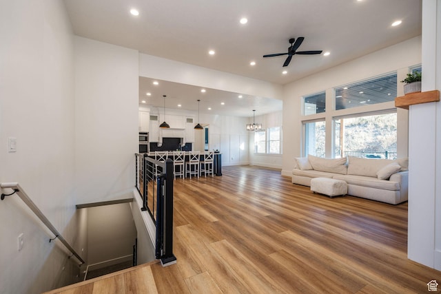 104 S 950 E, Hyde Park, UT 84318 - living area featuring baseboards, recessed lighting, light wood-style floors, ceiling fan, and a chandelier