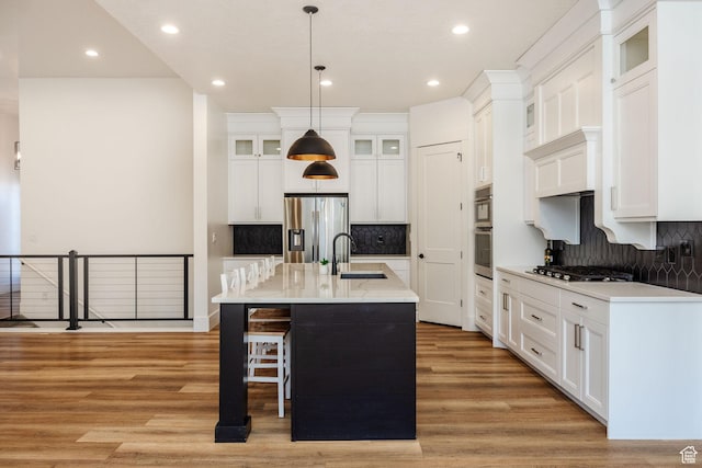 104 S 950 E, Hyde Park, UT 84318 - kitchen with appliances with stainless steel finishes, a sink, light wood finished floors, recessed lighting, and tasteful backsplash