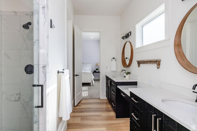 104 S 950 E, Hyde Park, UT 84318 - ensuite bathroom with a shower stall, two vanities, and wood finished floors