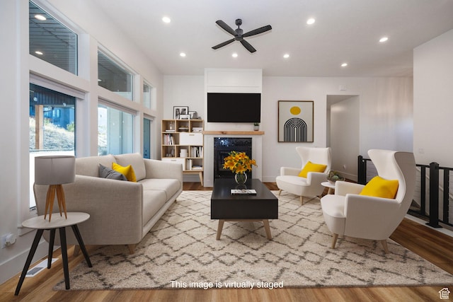 104 S 950 E, Hyde Park, UT 84318 - living area featuring a ceiling fan, wood finished floors, recessed lighting, and a lit fireplace