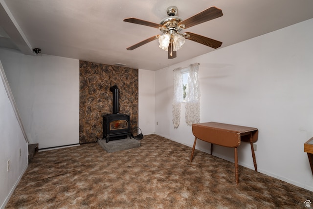 1390 N 500 W, Vernal, UT 84078 - unfurnished living room featuring a wood stove, ceiling fan, and dark colored carpet